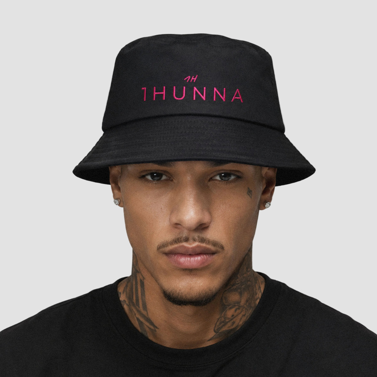 Black Casual Bucket Hat with pink 1HUNNA branding – front worn view