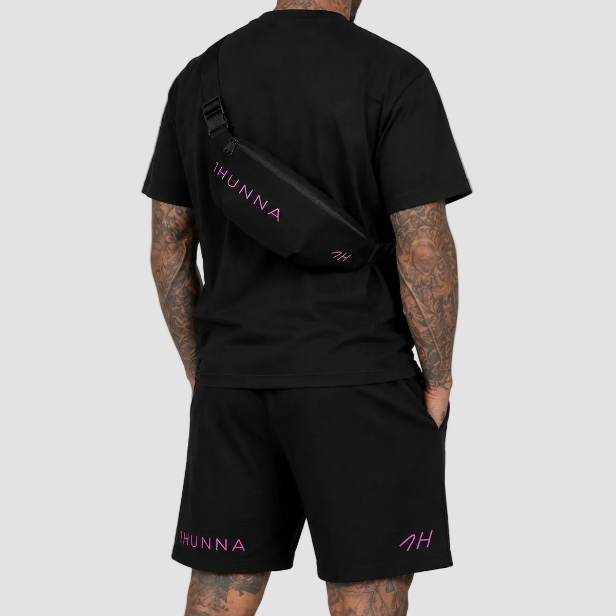 Black Casual Crossbody Bag with pink branding – worn across the back